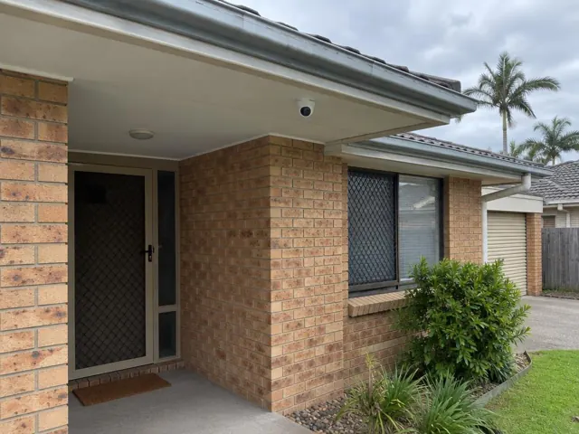 Exterior brick home with a CCTV camera mounted under the eave in Burleigh Waters