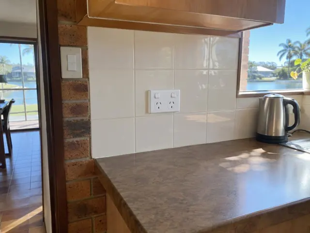 Kitchen backsplash with a new double power point above a benchtop beside a window in Broadbeach Waters
